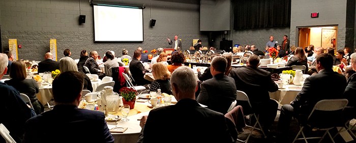 Ambassador day photo of room full of attendees and speaker