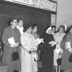 nun smiling with students