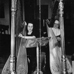 student participating in a harp lesson