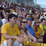 group of smiling students at homecoming football game