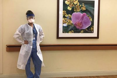 female nurse standing in hospital hallway