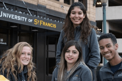 smiling students in front of st bonaventure campus