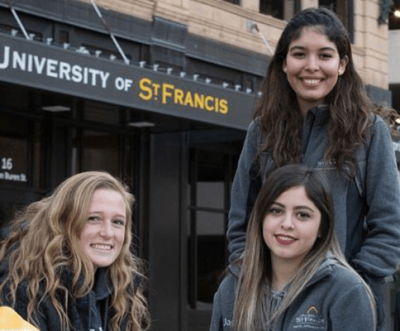 smiling students in front of st bonaventure campus