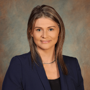 image of a women with medium length brown hair and smiling