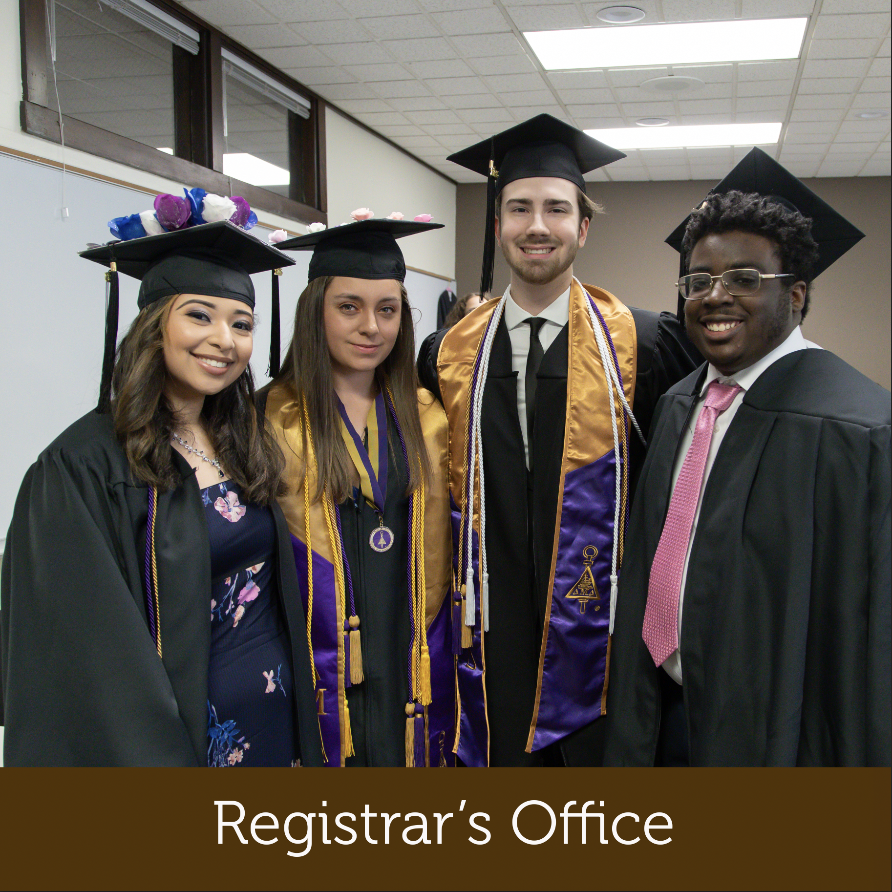 four graduates with caps and gowns on